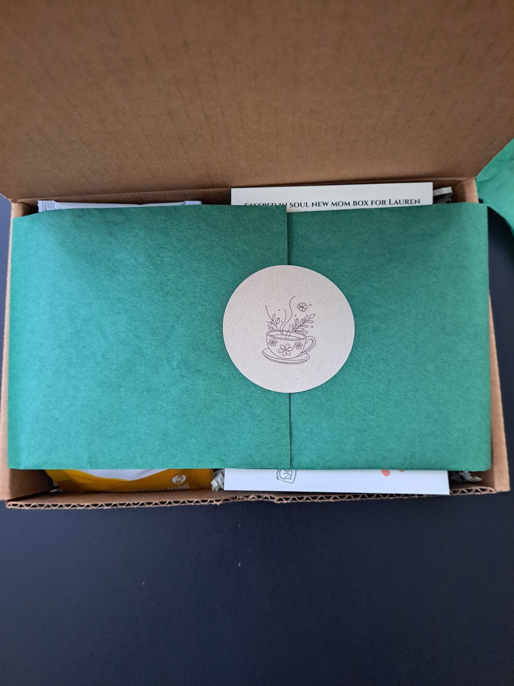 Tea Box wrapped in green tissue paper

