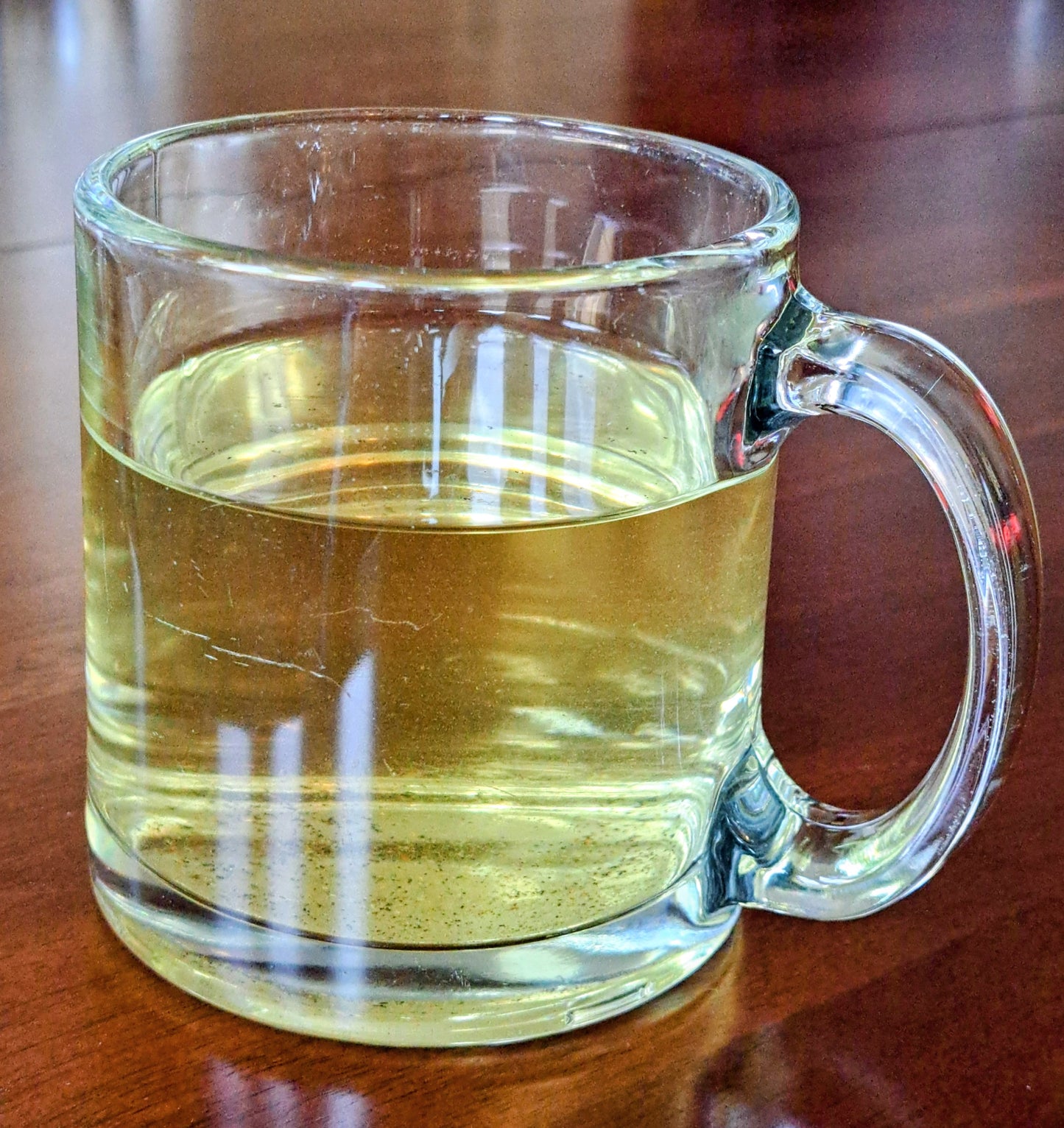 Clear glass mug filled with green tea